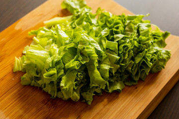 freshly cut lettuce on a wooden cutting board