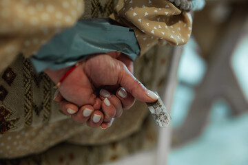 Close up of woman hands tying with a rope and holding a blade in the basement. Kidnapping, violence concept