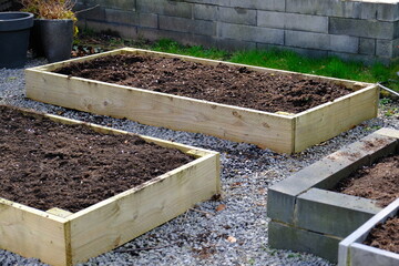 Empty raised beds in a garden in spring. Gardening Concept.