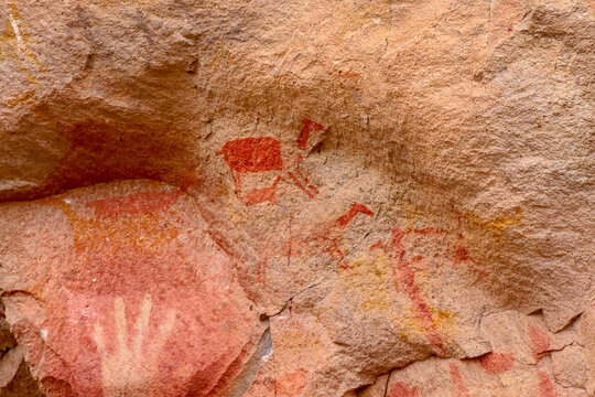 Close up of handprints and rock painting of llamas on rock walls at Cueva de las Manos, UNESCO World Heritage Site, Patagonia, Argentina