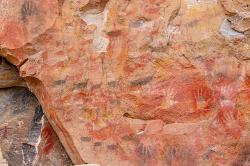 Colourful animal rockpaintings and handprints on rock walls at Cueva de las Manos, UNESCO World Heritage Site, Patagonia, Argentina
