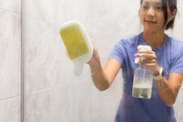 Woman clean the hard water stains and deposits in bathroom - 762412241