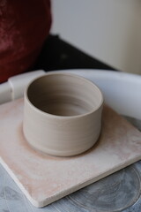 Person doing pottery in a studio. Vertical.