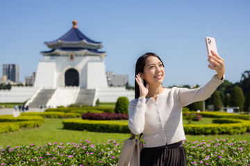 Tourist woman take photo on mobile phone in Chiang Kai shek Memorial Hall in Taipei of Taiwan - 762414224