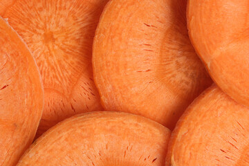 Background carrot sliced into rings closeup.
