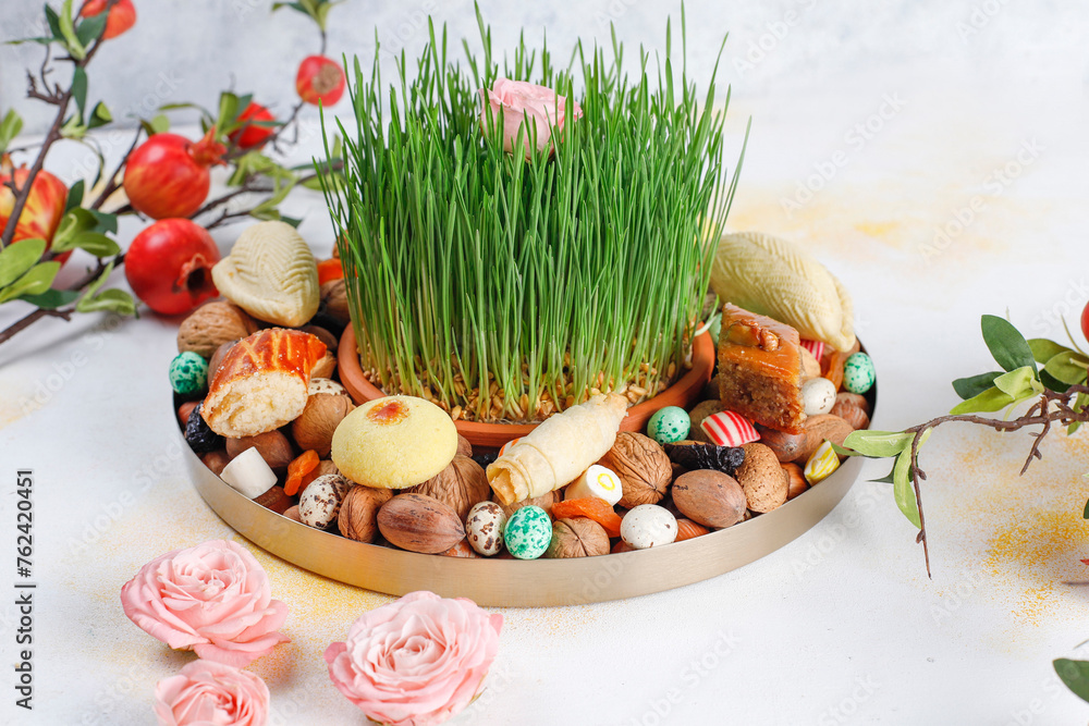 Canvas Prints Traditional Azerbaijan holiday Novruz background with green semeni,traditional azerbaijan sweets,shekerbura,qogal,paxlava,mutaki and different nuts and sweets,top view,space for copy