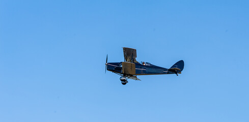 A De Havilland bi-winged Fox Moth flying at an airshow - obrazy, fototapety, plakaty