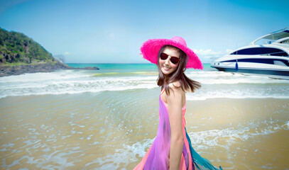 Asian girl enjoying a trip to the sea in colorful outfits on a yacht trip.
