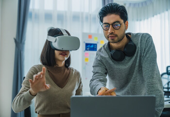 Asian and Indian developer program coding sent to virtual reality headset to implement ai project...