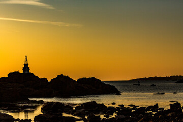 Naklejka premium Sunrise silhouette, lighthouse of Ahtopol, Black Sea, Bulgaria. Moody dark seascape