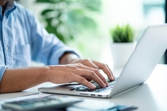 Businessman is managing data on computer Make reports with KPIs and indicators connected to the database. Corporate strategy for finance, sales, marketing