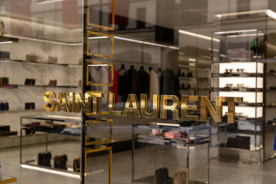 Yves Saint Laurent sign and logo at the entrance of luxury stores on Maximilanstrasse, Maximilian Street in Munich, Germany