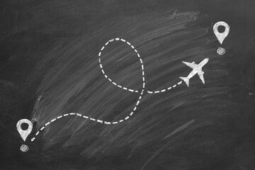 Airplane line path drawing on blackboard. Air plane icon with flight route. Travel dash route line, trip flight path. Dashed line with curl or loop. Transportation and travel concept.