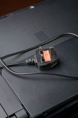 close-up of three pin ac power plug on printer or scanner device, british standard or type G plug...
