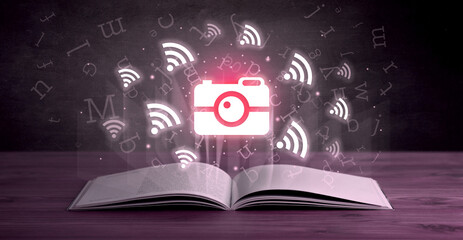 Open book with social networking icons above - 762456616