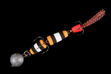 Artificial fishing bait for predatory fish shot from above on black