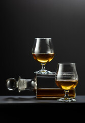 Old decanter and glasses with whiskey, cognac or brandy.
