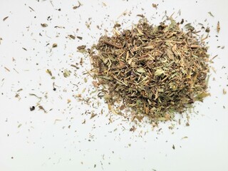 Dried pile of lemon thyme on bright background.
