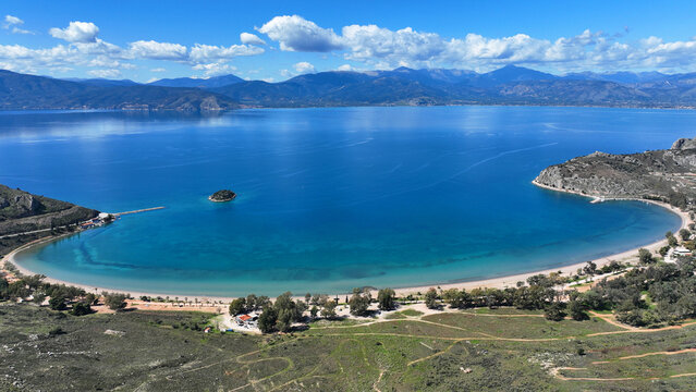 Aerial drone photo of paradise scenic round sandy beach of Karathonas next to historic city of Nafplio, Argolida, Greece