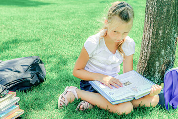 Children do homework in the park, a boy and a girl are preparing