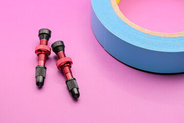 tubeless presta valves with tube less rim tape on plain background (cut out, isolated on magenta...