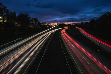 Fototapeta na wymiar Car trails at evening on 147 Freeway at Durham, NC-USA on March 2024.