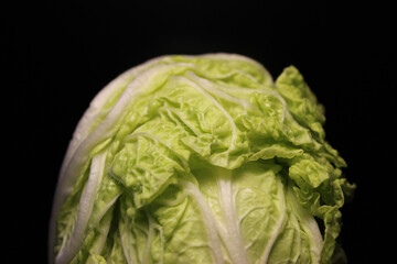 Top Part Of Napa Cabbage Head Isolated On Black Background 