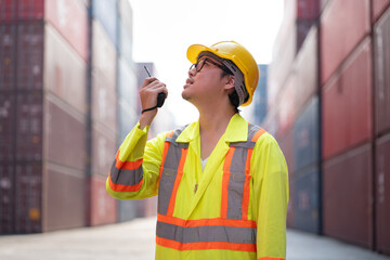 Asia logistic engineer man worker or foreman working with walkie talkie at container site	 - 762476865