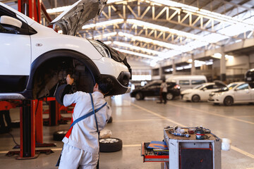car repair in garage service station with soft-focus and over light in the background