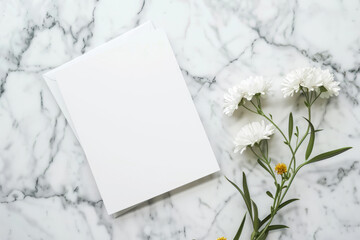 Minimalistic mockup of a blank white card with birth month flowers on a marble background for design presentation