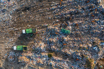 Aerial top down view of garbage trucks unload pile of waste at landfill. Dump of unsorted waste garbage pile in trash dump. Environmental pollution and ecological disaster. View from drone - 762482418