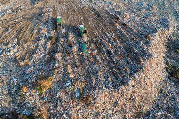 Aerial view of garbage pile in trash dump. Dump track unload waste at landfill. Biohazard for ecosystem and healthy environment concept. Environmental pollution and ecological disaster - 762483467
