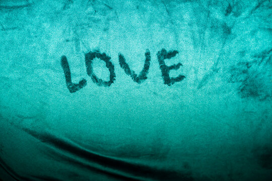 The inscription Love on fabric material.