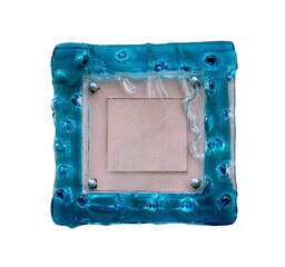 Square blue glass frame with cracks on a surface