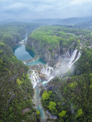 Amazing aerial view of Plitvice national park with lakes and picturesque waterfalls in a green spring forest, Croatia. - 762489470