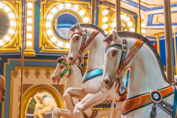 Old french carousel spins in a holiday park. Elephant horses on a traditional vintage fairground...
