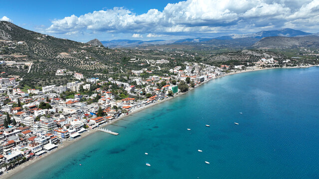 Aerial drone photo of famous seaside village small port and long sandy beach of Tolo with hotels and resorts built by the sea, Argolida, Peloponnese, Greece