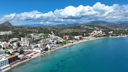 Fototapeta na wymiar Aerial drone photo of famous seaside village small port and long sandy beach of Tolo with hotels and resorts built by the sea, Argolida, Peloponnese, Greece