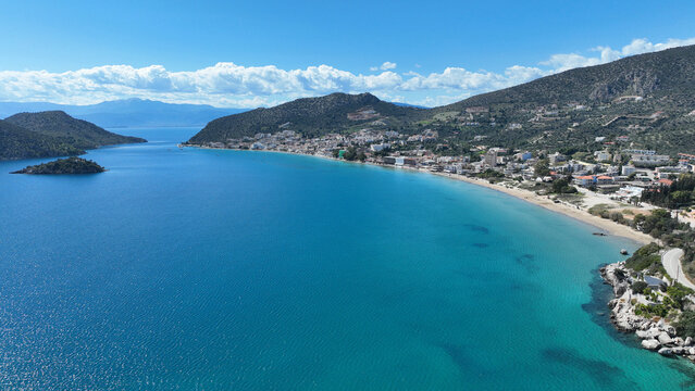 Aerial drone photo of famous seaside village small port and long sandy beach of Tolo with hotels and resorts built by the sea, Argolida, Peloponnese, Greece