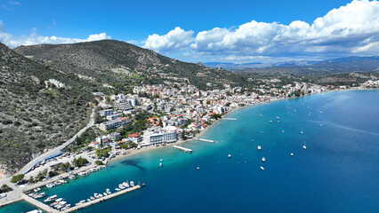 Obraz premium Aerial drone photo of famous seaside village small port and long sandy beach of Tolo with hotels and resorts built by the sea, Argolida, Peloponnese, Greece