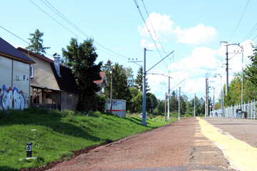 Fototapeta premium A small train station with no people. Sunny summer day.