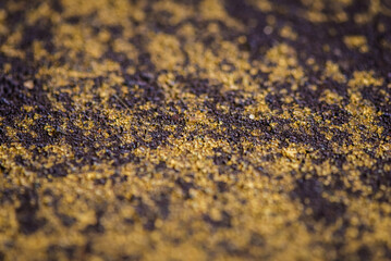 macro photo surface of a concrete inlet purple with yellow splashes background
