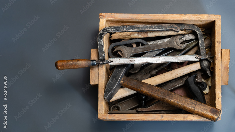 Wall mural An old carpentry tool in a wooden box on a gray background