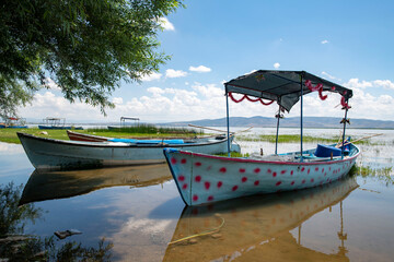 Decorated day-trip boats in Isikli Lake in Denizli's Civril district. Isıkli Lake is flooded with...