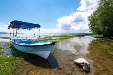 Naklejka na ściany i meble Decorated day-trip boats in Isikli Lake in Denizli's Civril district. Isıkli Lake is flooded with visitors during lotus time. It is also a popular lake for hunters.