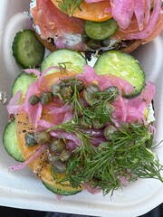 Fancy fresh bagel with salmon, capers, chives, cucumber and cream cheese toppings - 762509095