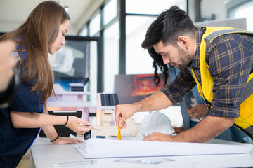 Obraz premium Engineers, architects, and designers collaborate to design a building that employs natural energy.