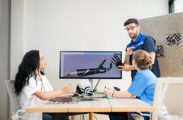 Engineers, doctors and physical therapists brainstorm ideas to design a robot with arm and hand organs, To be utilized for additional testing on patients.
