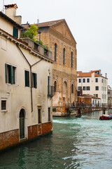 Cozy narrow canals of Venice city with old traditional architecture, bridges and boats, Veneto, Italy. Tourism concept. Architecture and landmark of Venice. Cozy cityscape of Venice.