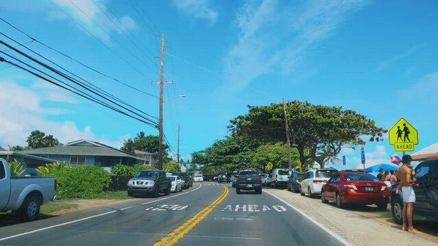 High-speed driver's pov of oceanside road in Honolulu on Oahu, Hawaii. Timelapse of a car driving through town road near the ocean.